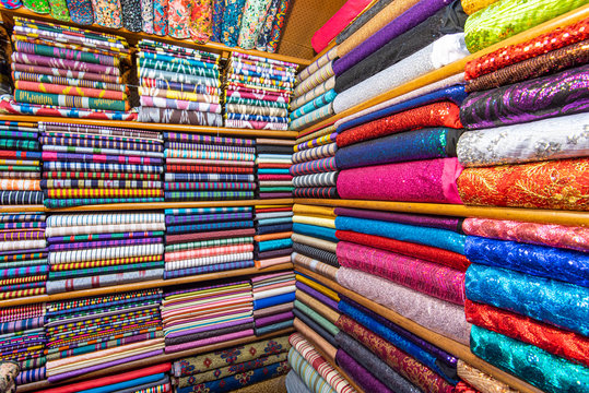 Colored textile or fabric at a street Asian Market, shelves with rolls of fabric and textiles