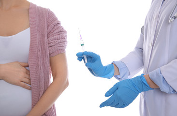 Doctor giving injection to pregnant woman on white background, closeup. Vaccination concept