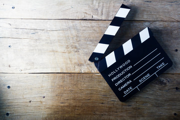 Clapper board on wooden table.