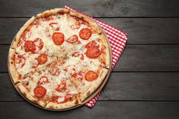 Delicious pizza Margherita on wooden table, top view