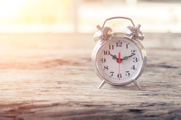 Alarm clock on wooden table.