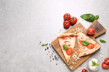 Slices of delicious pizza Margherita on light grey table, flat lay. Space for text
