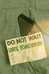 Writing note showing Do Not Wait Until Tomorrow. Business concept for needed to do it right away Urgent Better do now Smartphone device inside trousers front pocket note paper