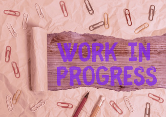 Conceptual hand writing showing Work In Progress. Concept meaning unfinished project that still...