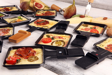 Delicious traditional Swiss melted raclette cheese on diced boiled or baked potato.