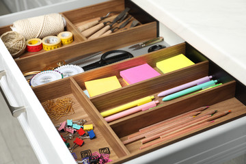 Different stationery in open desk drawer indoors, closeup