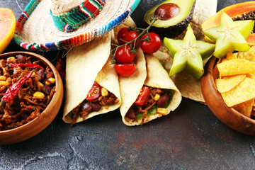 Mexican food mix in colorful colors. sombrero and mexican food with tacos