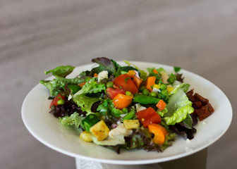 A fresh vegetable salad. Green salad on a white plate. Food.