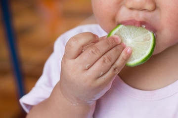 baby eating lemon