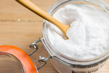 Closeup baking soda on wooden blackground