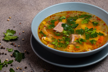 Delicious spicy soup with beef and noodle on grey background. Close-up