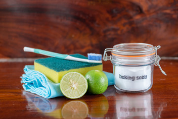 Baking soda with lemon on wooden background