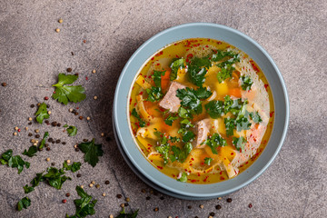 Delicious spicy soup with beef and noodle on grey background. Top view.