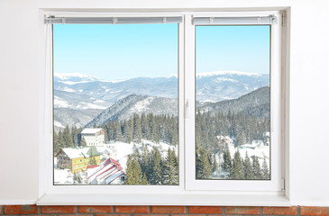 Beautiful view of snowy forest through big window