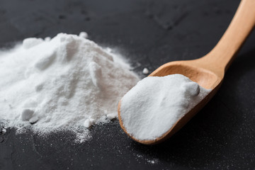 baking soda in wooden spoon.
