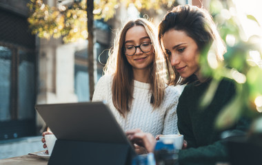 Freelancer communicate on project, friends shopping online on wifi tablet in cafe outdoor. Students studies on internet. Working business process concept