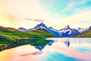 Fantastic landscape at sunrise over the lake in the Swiss Alps, Europe. Wetterhorn, Schreckhorn,...