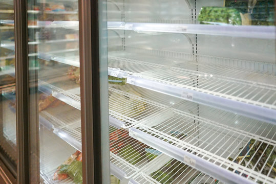 Empty Frozen Food Section In European Supermarket During Fear And Panic Shopping Because Of Covid-19 Virus