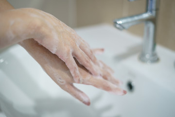 Washing hands with soap. For killing germs, bacteria and virus.