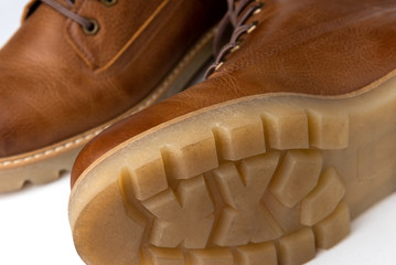 Red winter leather boots isolated on white background.