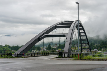 Bridge steel frame with asphalt road. Bridge in Japanese countryside