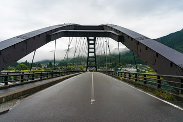 Bridge steel frame with asphalt road. Bridge in Japanese countryside