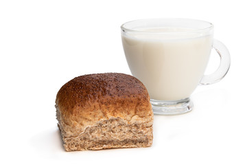 Freshly baked wheat bun and glass of milk isolated on white