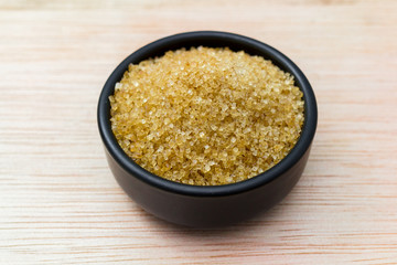 sugar in bowl on wooden table