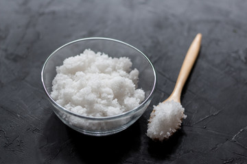 Salt in a cup on a wooden table