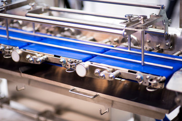 pharmaceutical packing production line conveyer at manufacture pharmacy factory. Authentic shot in...
