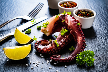 Fried octopus and vegetables on wooden table © Jacek Chabraszewski