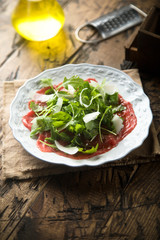 Beef carpaccio with arugula and Parmesan cheese