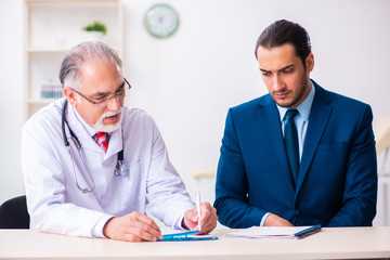 Male doctor and businessman discussing medical project