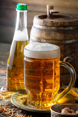 Light beer in a glass on a table in composition with accessories on an old background