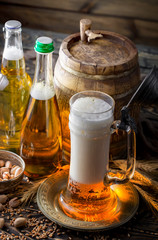 Light beer in a glass, on an old background.