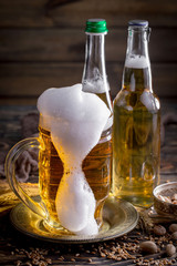 Light beer in a glass on a table in composition with accessories on an old background