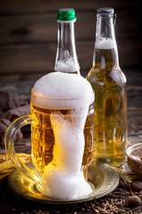 Light beer in a glass, on an old background.