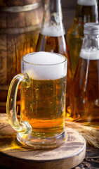 Light beer in a glass on a table in composition with accessories on an old background