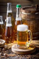 Light beer in a glass on a table in composition with accessories on an old background