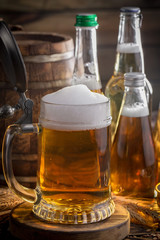 Light beer in a glass on a table in composition with accessories on an old background