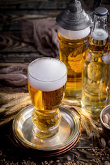 Light beer in a glass on a table in composition with accessories on an old background