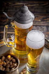 Light beer in a glass, on an old background.