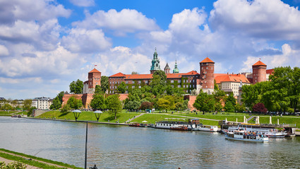 Wawel castle - famous landmark in Krakow Poland. Picturesque landscape on coast Vistula river during the sunny day.