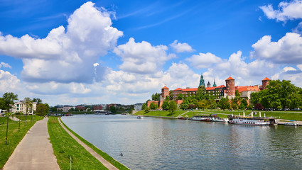 Fototapeta Wawel castle - famous landmark in Krakow Poland. Picturesque landscape on coast Vistula river during the sunny day. obraz