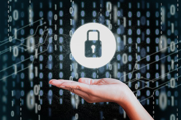 A lock icon in a woman's hand on a digital background