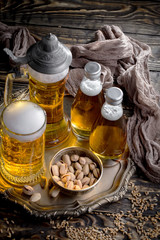 Light beer in a glass on a table in composition with accessories on an old background