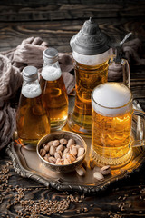 Light beer in a glass, on an old background.