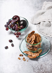 Dried bread made from wheat flour,  honey, walnuts, plums and grapes. Homemade healthy food concept. Copy space.