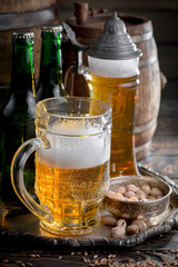 Light beer in a glass on a table in composition with accessories on an old background