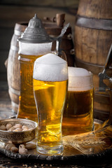 Light beer in a glass on a table in composition with accessories on an old background
